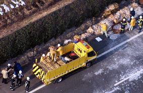 Workers clean up explosives spilled in road accident